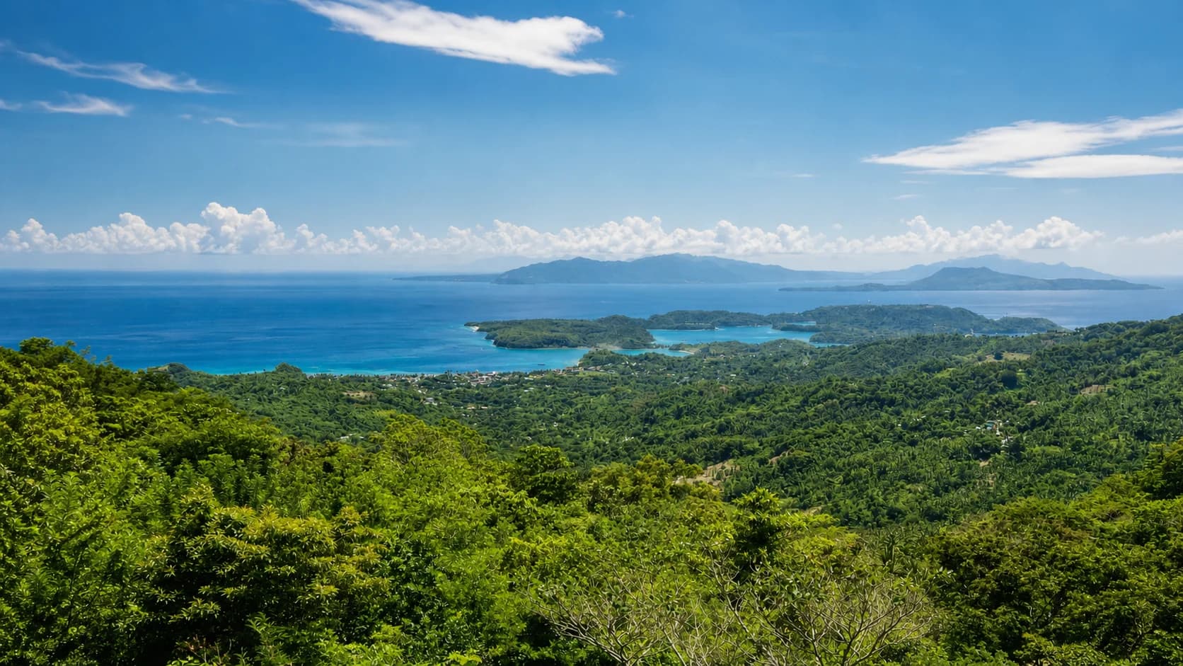 View over Puerto Galera's green hills, bays and surrounding islands from Ponderosa